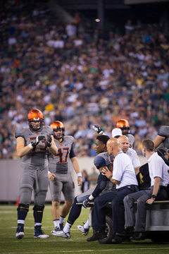 Sam Rodgers and Jon Burton look on as Kendall Moore is taken off after suffering a concussion in the fourth quarter.