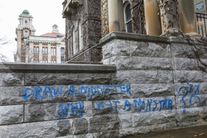 A spray painted message on Syracuse University's Smith Hall reads 