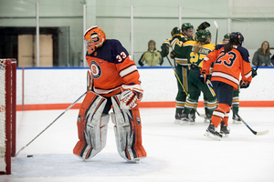 Syracuse goaltender Jenn Gilligan drags the puck out of the net after one of Clarkson's three goals. The Orange defense held firm for the most part after allowing two goals in the first period.