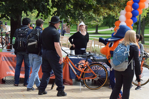 Syracuse University mascot Otto the Orange checked the first bike from the bike share program and  rode it down the University Place promenade. 