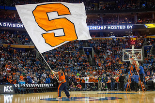 A Syracuse cheerleader waves a giant flag prior to the game. 