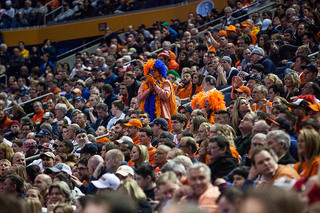 A die-hard Syracuse fan stands in the middle of the fan section. 