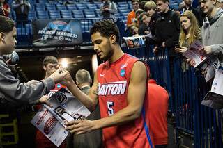 Dayton forward Devin Oliver signs an autograph.