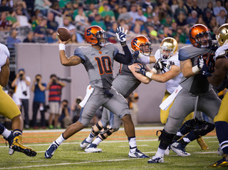 Syracuse quarterback Terrel Hunt prepares to throw as left tackle Sean Hickey and center John Miller protect him.
