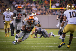 Syracuse running back Prince-Tyson Gulley moves downfield with safety Max Redfield preparing to make the tackle.