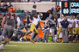 Syracuse safety Durell Eskridge intercepts a Golson pass in the fourth quarter, which he brought back for a touchdown.