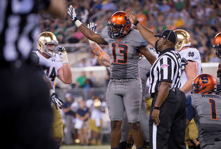 Defensive end Ron Thompson signals for a first down after the referees decide that Syracuse successfully recovered Bryant's fumble.