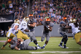 Orange running back Adonis Ameen-Moore finds a hole as the Syracuse offensive line clears space. 