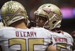 Florida State quarterback Jameis Winston and tight end Nick O'Leary talk on the sideline.  