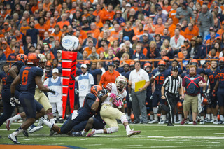 Winston gets tackled by a Syracuse player. The FSU quarterback was strong in the air but the Orange front was able to generate pressure on him. 