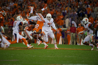 A Clemson rusher is brought down hard on by an SU tackle.