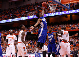 Hampton's Brian Darden attempts a finish as Tyler Roberson (second from left) and Rakeem Christmas (right) watch on.