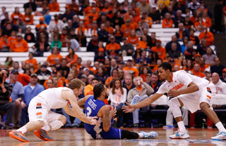 Trevor Cooney (left) and Gbinije (right) lunge for a loose ball with a Hampton player. 