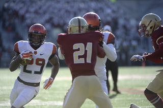 Running back Devante McFarlane looks to make a move as Boston College defensive back Manuel Asprilla tries to shed a block.