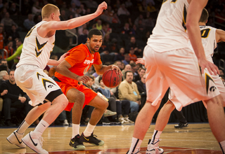 Gbinije works his way into the paint against a Hawkeyes' defender.
