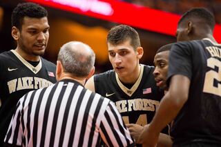 Mitoglou and his WFU teammates talk with an official.