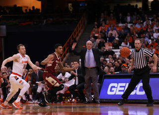 Cooney looks to chase after a loose ball as head coach Jim Boeheim raises both his hands from the sideline.