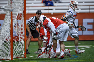 Dylan Donahue walks past a demoralized Cornell goalie and one defender after scoring a goal for the Orange. 