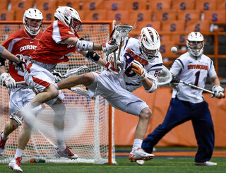 Syracuse's Jay McDermott fights with a Cornell player for ball control. 