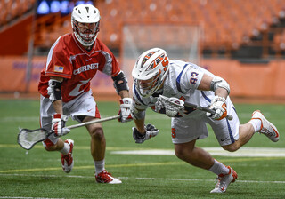 Ralph D'Agostino escapes from a Cornell player while managing to keep the ball in bounds.