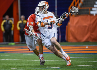 Nicky Galasso prepares to pass the ball to another Orange player as he heads down the alley. 