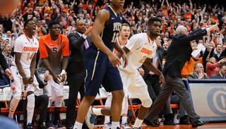 The Syracuse sideline reacts as the Orange mounts a comeback in the second half.