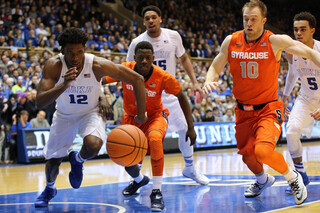Winslow chases after a loose ball while SU point guard Kaleb Joseph follows suit.