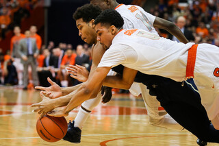 Gbinije dives for a loose ball on the Carrier Dome court. 