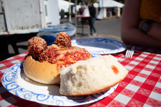 Guests dig into a meatball dish larger than they can finish. This year, organizers took pride in their expanded assembly of authentic Italian dishes.