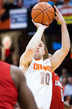 Trevor Cooney elevates for a jumper as Rozier reaches out a hand. The Syracuse junior guard shot only 1-of-6 in the first frame.