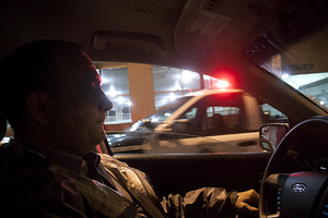 John Sardino, associate chief of DPS, rides past a safety checkpoint on Waverly Avenue. Sardino has been working extra hours to crack down on recent crime. 