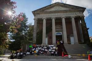 Students stage a silent protest on the steps of Hendricks Chapel on Thursday afternoon while a SU-sponsored diversity forum took place inside the building.