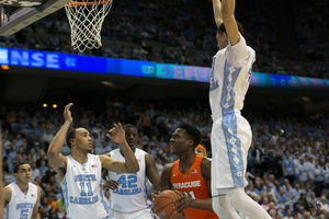 Tyler Roberson maneuvers through two UNC defenders Monday night. The junior rebounded from a string of lackluster performances,