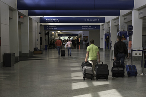 The federal government tightens airport security after the Sept. 11 attacks. 