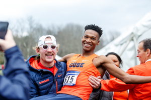 Justyn Knight, pictured after winning the cross country national title, has now won 14 ACC titles, including nine as an individual, after his 5000-meter race win on Friday.