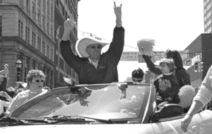 Coach Jim Boeheim, wearing his giant orange cowboy hat, rides in the parade honoring the 2003 NCAA national champions Saturday.