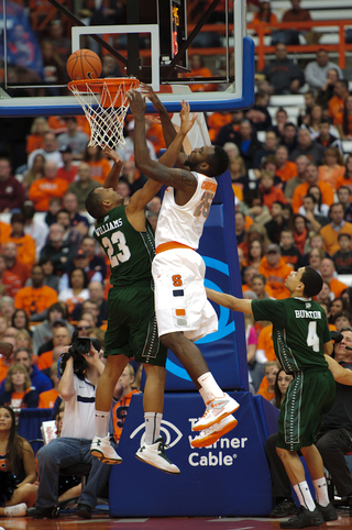 Syracuse forward Rakeem Christmas tries putting the ball in over guard Jonathon Williams.