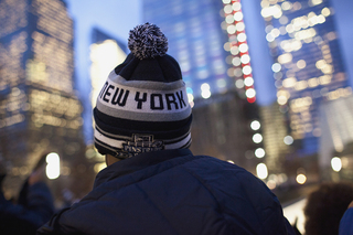 A Syracuse football player dons a winter hat with the words 