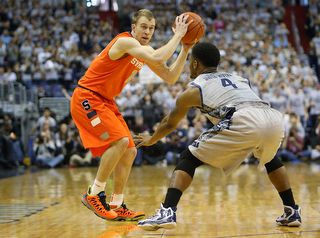 Trevor Cooney squares up and looks for a shot against Georgetown guard D'Vauntes Smith-Rivera.