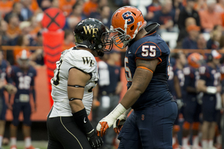 Syracuse guard Rob Trudo jaws with Whitlock.