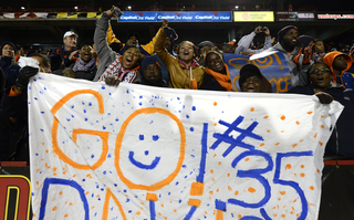 Dyshawn Davis' family celebrates and cheers for him. Davis finished with five tackles and one sack.