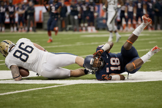 Syracuse defensive back Darius Kelly knocks Pittsburgh tight end J.P. Holtz down after a catch.