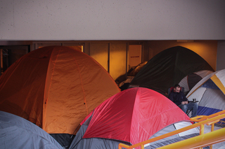 Ryan Roach, a junior international relations and history major, sits outside of his tent by Gate D of the Carrier Dome. He said he's been camped out here since Tuesday.