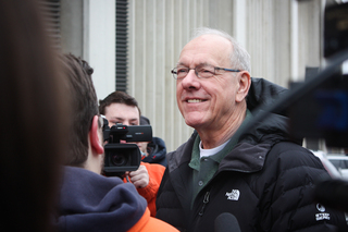 Jim Boeheim talks to students and press after arriving at Gate E of the Carrier Dome. Boeheim spoke with members of Otto's Army and took pictures with fans.