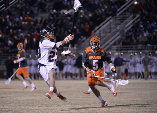 Long-stick midfielder Tanner Ottenbreit is closed in on by Nicky  Galasso while hauling in a pass. 