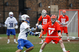 Orange longstick midfielder Matt Harris stands between a Duke attack and the SU goal. 