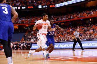 Gbinije dribbles by the Pirates' Dionte Adams as Chievous looks on.