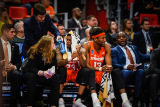 A towel covers Howard's head. To his right is junior center Paschal Chukwu, who scored one point and grabbed two rebounds. 