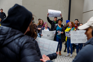 Dozens of students show up to the protest with handmade signs demanding the administration do more in regard to the suspension.